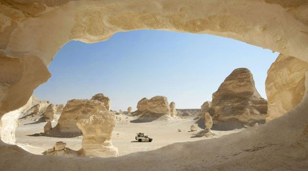 A vehicle passes chalk Inselbergs in the White Desert, a region in Egypt's vast Western Desert where at least two Mexicans mistaken for jihadists were part of a group of 12 people killed by security forces/AFP