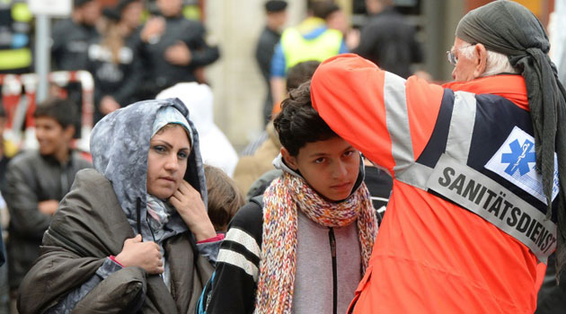 Medical staff check migrants after their arrival at the main railway station in Munich, southern Germany, on September 6, 2015/AFP