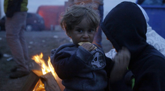 Women and children were caught in the chaotic scrum as hungry people frantically tried to catch the bread flying through the air/AFP