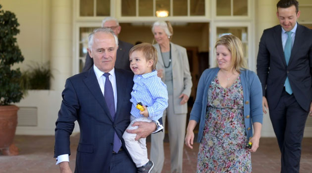 Malcolm Turnbull arrives with his grandson Jack Turnbull Brown to pose for photos, after being sworn in as Australia's 29th Prime Minister, at Government House in Canberra, on September 15, 2015/AFP