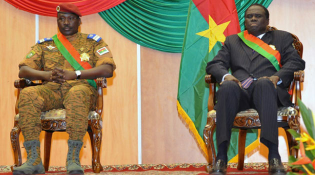 Burkina Faso's Prime Minister Lt. Col. Isaac Zida (L) and interim President Michel Kafando (R) listen during Kafando's inauguration ceremony on November 21, 2014 in Ouagadougou/AFP