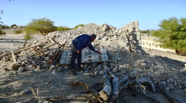 File picture shows a resident looking at the ruins of the mausoleum of Alfa Moya, a Muslim saint, which was destroyed by Islamists in a cemetery in Timbuktu/AFP  