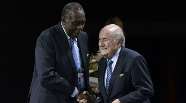 Sepp Blatter (right) shakes hands with Issa Hayatou after being re-elected as president during the FIFA Congress in Zurich on May 29, 2015/AFP