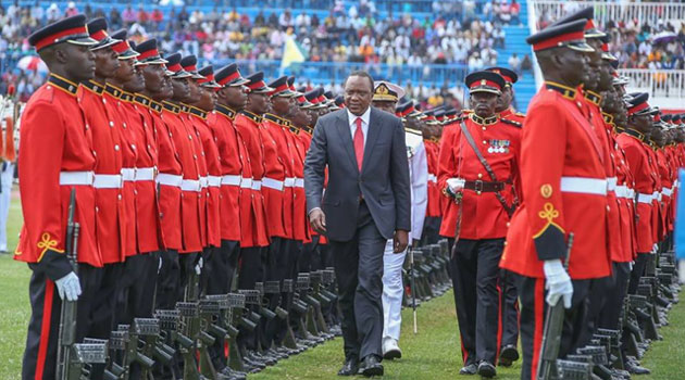 President Kenyatta inspects a guard of honour during the 6th Mashujaa Day fete.