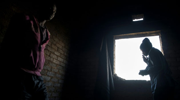 Addicts of the drug cocktail known locally as 'nyaope' gather inside an abandoned building in Simuneye township on the outskirts of Johannesburg  © AFP