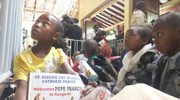 Children seated waiting for the Pope to arrive