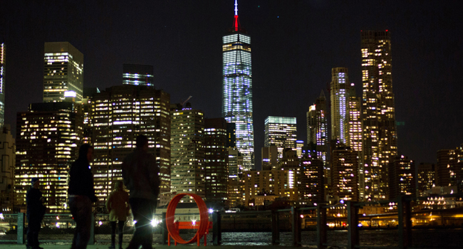 The One World Trade Center spire is lit up in blue, white and red/AFP