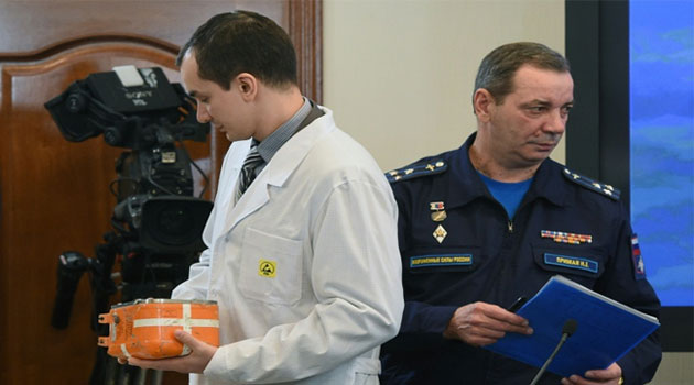 A specialist in Moscow takes away the flight recorder from the Russian Sukhoi Su-24 bomber that was shot down by a Turkish jet on November 24  © AFP