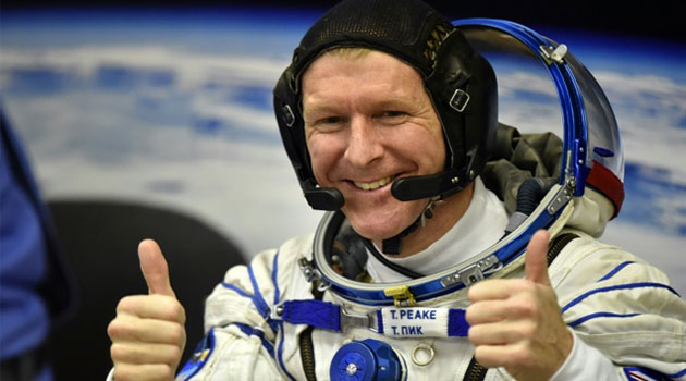 Britain's astronaut Tim Peake gestures as his space suit is tested at the Russian-leased Baikonur cosmodrome, prior to blasting off to the International Space Station (ISS), on December 15, 2015  © AFP