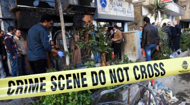 Investigators attend the scene of a petrol bomb attack on a Cairo disco on December 4, 2015/AFP  