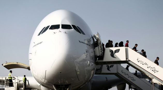 Passengers disembark from an Emirates Airline Airbus A380-800 at Tehran's IKA airport on September 30, 2014/AFP