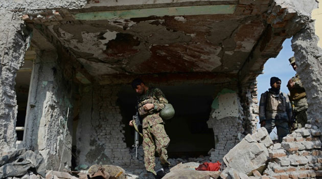 Afghan security personnel inspect a building used by insurgents to launch an attack on the Pakistan consulate in Jalalabad/AFP