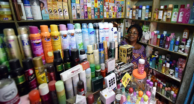 A woman selling whitening creams in Ivory Coast/AFP