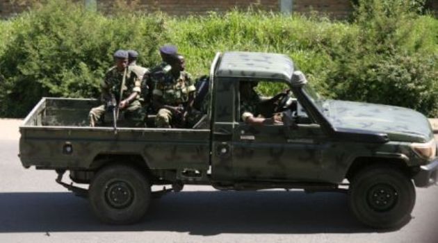 Military personnel sits aboard a vehicle driving Bujumbura/AFP