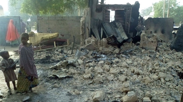 Children stand near the rubble of a burnt house after Boko Haram attacks at Dalori village on the outskirts of Maiduguri in northeastern Nigeria on January 31. Photo/ AFP