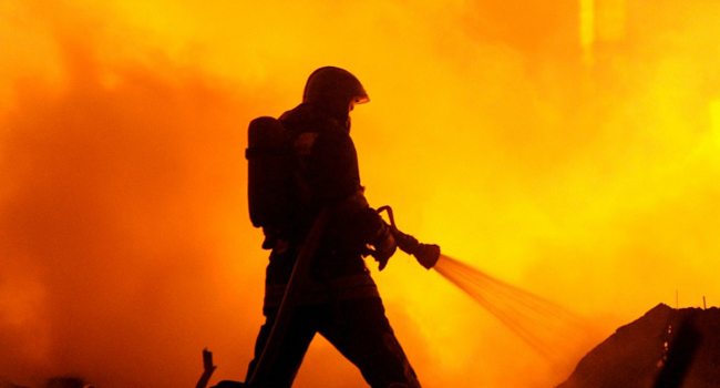 A fireman battling raging flames/FILE