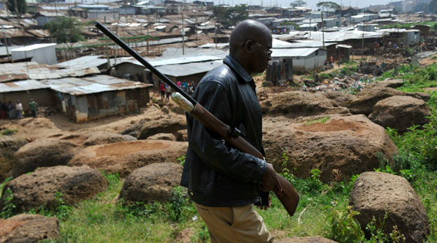 A Kenya Wildlife Service (KWS) officer carries a tranquilizer gun during a search for two lions on February 19, 2016 that left Nairobi National Park and went into "highly populated" areas of the Kenyan capital/AFP