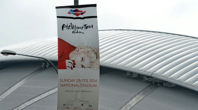 A banner promotes US singer Madonna's upcoming February 28 concert in front of the National Stadium in Singapore/AFP