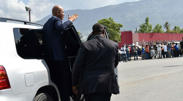 Haitian President Michel Martelly greets supporters as he departs the Parliament after delivering his farewell speech on February 7, 2016 in Port-au-Prince/AFP