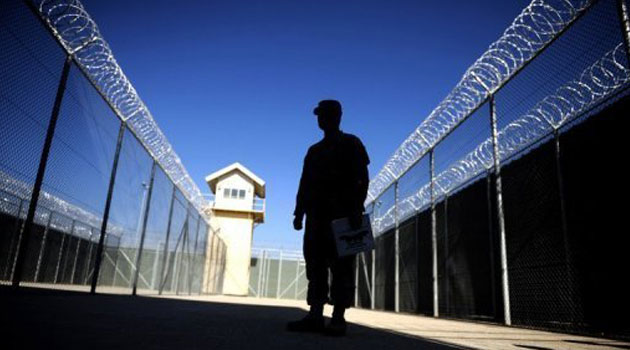 A warden standing in a prison facility/FILE