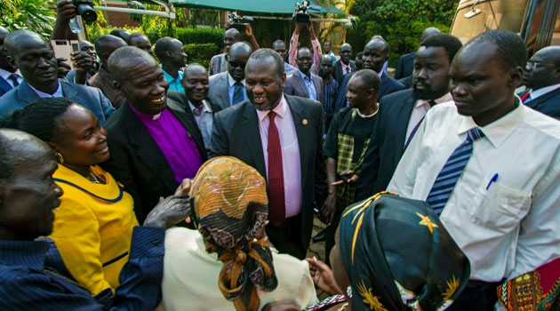 South Sudan's rebel leader Riek Machar (C) has been named as vice-president of South Sudan by his arch-rival Salva Kiir/AFP