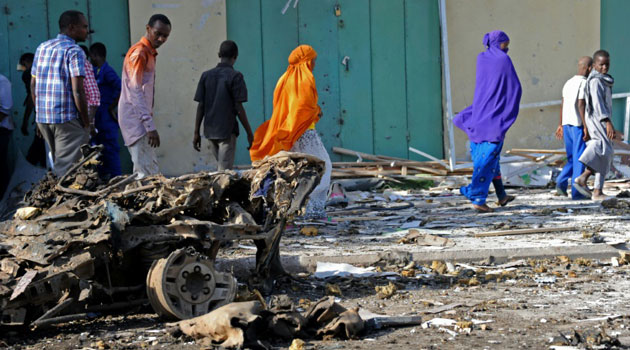 Residents walk by a previous scene of an Al Shabaab attack in Somalia. The latest attack on Sunday killed more than 30 in Baidoa. Photo/ FILE