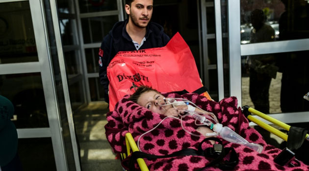 An injured northern Syrian child is carried on a stretcher at a hospital in the southern Turkish border town of Kilis on February 16, 2016/AFP