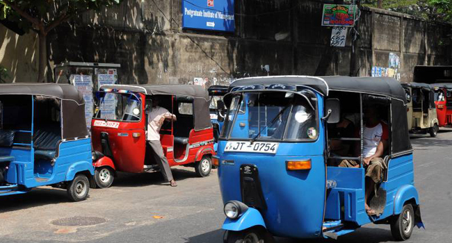 A Tuk tuk driver offering transport services/AFP