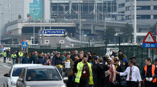 Passengers are evacuated from Brussels airport in Zaventem, on March 22, 2016, after twin blasts rocked the main terminal/AFP