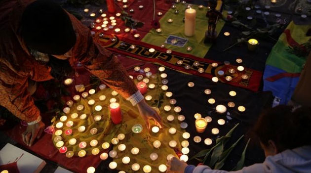 Wrapped in the national flag and carrying candles and flowers, Belgians flocked in their hundreds to the Place de la Bourse in the ancient heart of the city to grieve as the country held three days of national mourning/AFP