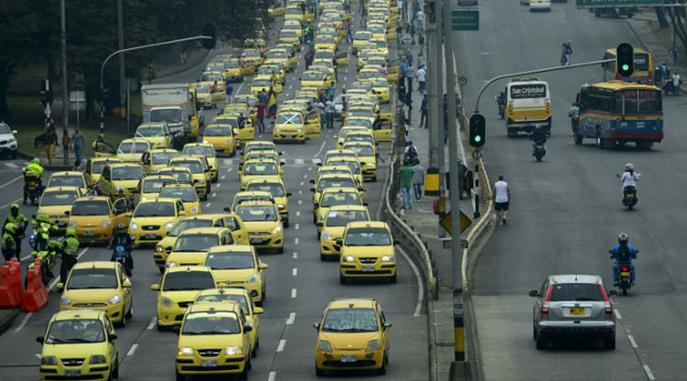 Thousands of taxi drivers gather in Bogota, on March 14, 2016 to protest against the Uber taxi-booking mobile service, leading to traffic congestion across the Colombian capital/AFP