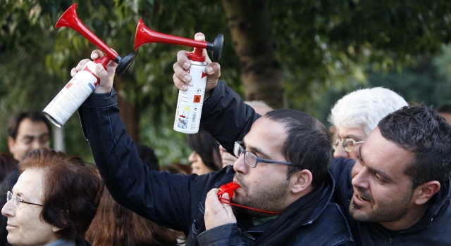 Civil servants hold placards and blow bullhorns as they walk off their job in Nicosia in 2011 protesting the government's economic austerity measures.EPA/KATIA CHRISTODOULOU