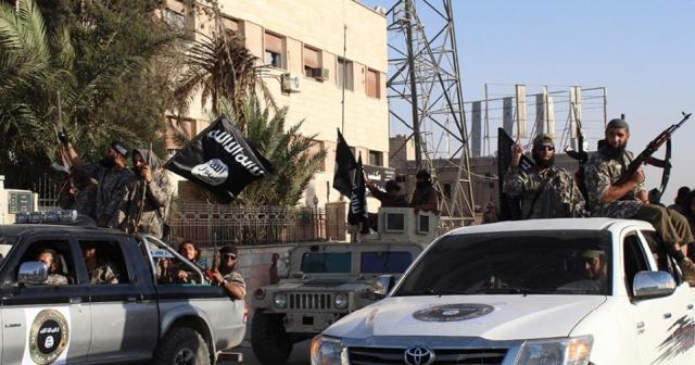 An image made available by Jihadist media outlet Welayat Raqa, allegedly shows members of the Islamic State group parading in a street in the northern rebel-held Syrian city of Raqa/AFP