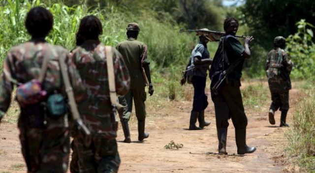 Rebels from the Lord's Resistance Army (LRA) make their way to an LRA camp set up in Owinykibul in Sudan.EPA/STEPHEN MORRISON