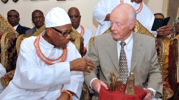 Prince Edun Akenzua (left) speaks with retired hospital consultant Mark Walker holding two bronze artefacts he returned to the Benin kingdom during a ceremony in Benin City, Nigeria, on June 20, 2014/AFP