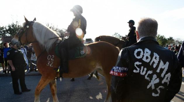 US police stand between Trump protesters and supporters prior to a rally in Boca Raton, Florida/AFP