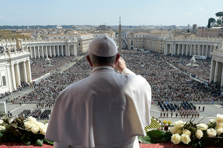 Pope Francis waves to worshippers as he delivers his Easter message at St Peter's Square/AFP