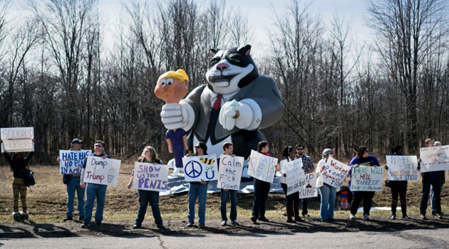 Protesters gather across the street before a Trump rally at the International Exposition Center March 12, 2016 in Cleveland, Ohio/AFP