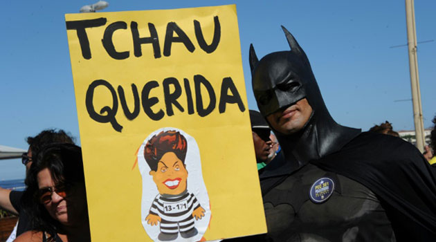 A man dressed as Batman holds a sign reading "Bye Darling" during a protest in favor of the impeachment of Brazil's President Dilma Rousseff in Copacabana, Rio de Janeiro, on April 17, 2016/AFP