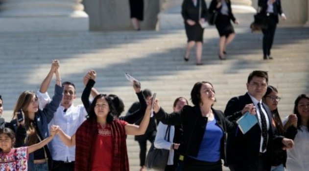  Supporters of US President Barack Obama's immigration reforms leave the US Supreme Court after arguments in United States vs Texas were heard April 18, 2016 in Washington, DC/AFP