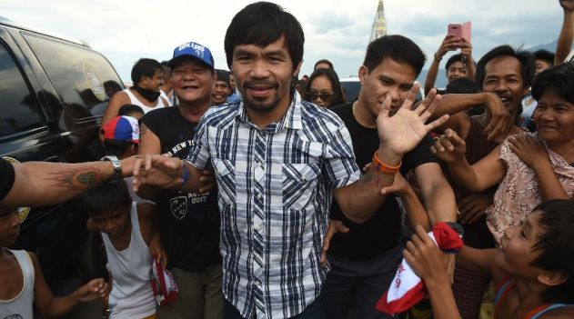 Surveys show Pacquiao is virtually guaranteed to win a Senate seat and his journey through shanty towns near Manila, where he threw caps and other souvenirs to joyous fans is more like a victory lap/AFP