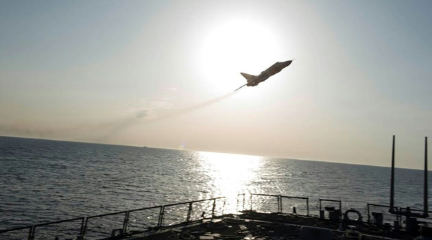 A Russian Sukhoi Su-24 attack aircraft makes a very-low altitude pass by the USS Donald Cook operating in the Baltic Sea/AFP