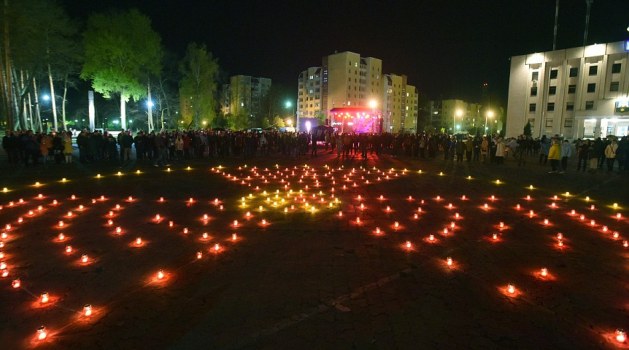 Candles set in the shape of a radiation hazard symbol are seen on a square next to the monument to Chernobyl victims in Slavutych on the 30th anniversary of the nuclear power plant disaster which has killed thousands and permanently poisoned swathes of eastern Europe - AFP/Getty