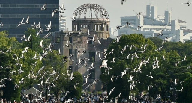 Doves fly over the Hiroshima Peace Memorial Park in Hiroshima, western Japan during a memorial ceremony to mark the 70th anniversary of the atomic bombing/AFP