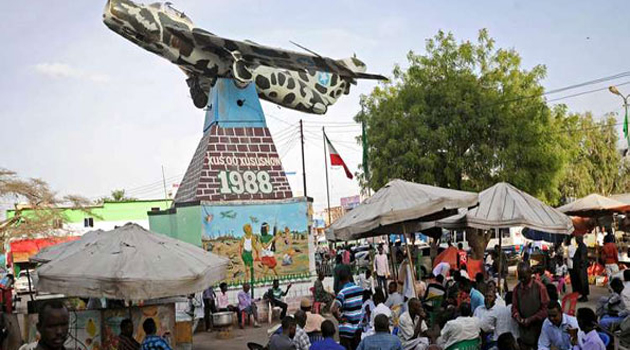 People sit under a Soviet-era MiG fighter jet hanging in Somaliland's capital as a monument and reminder of the bombing of Hargeisa by Somali President Mohamed Siad Barre in 1988. AFP