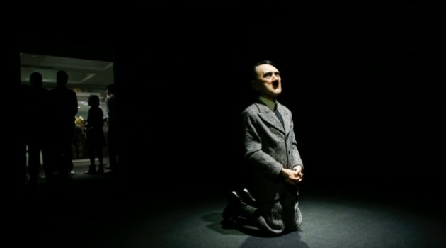 The statue of Hitler on his knees, by Italian artist Maurizio Cattelan, has been auctioned for $17.2 million/AFP