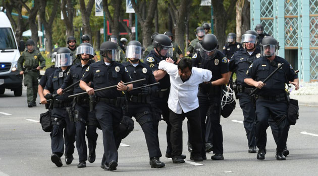 Police arrest a protestor during an anti-Trump demonstration outside the Anaheim Convention Center/AFP