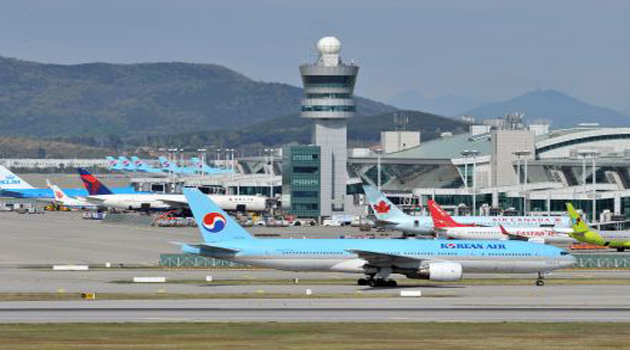 Korean Air Lines evacuated 300 passengers and crew from an aircraft at Japan's Haneda Airport in Tokyo after smoke came from its left engine, NHK reported/AFP