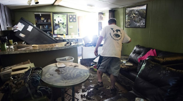 Larry Brooks walks through his trailer which was destroyed by flood waters in Elkview, West Virginia/AFP