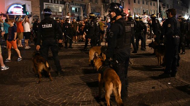 Riot police and their dogs stand guard in Marseille, southeastern France, on June 10, 2016/AFP